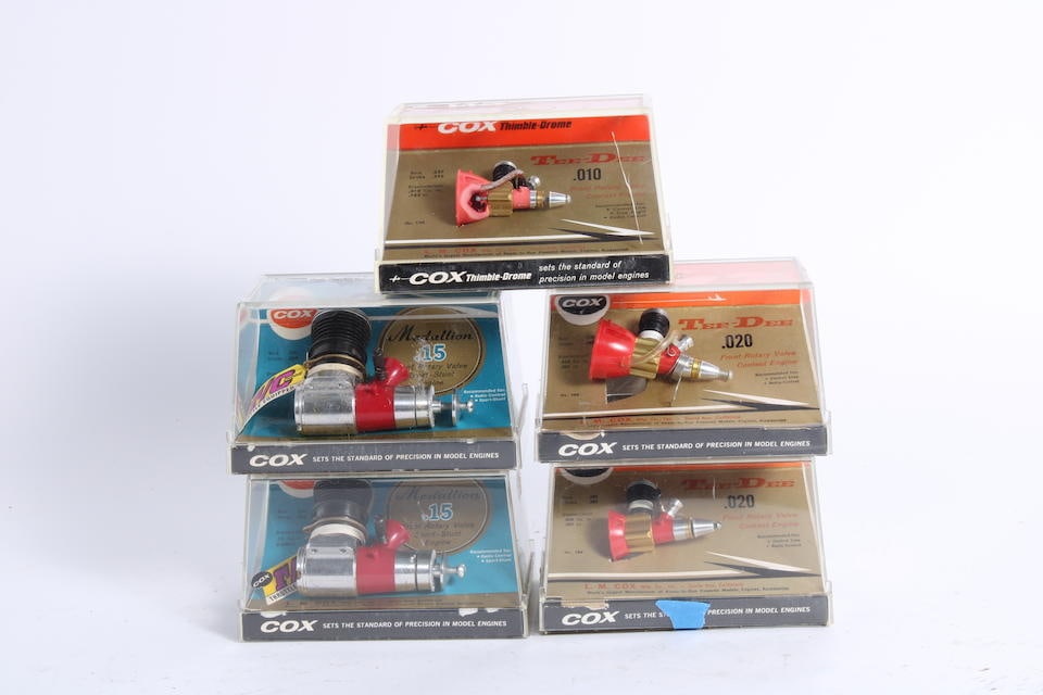 Five Cox gas powered miniature engines in Perspex shop display boxes, (5): Five Cox gas powered miniature engines in Perspex shop display boxes, new/old stock, comprising .010 Tee-Dee; 2 x Medallion .15 and two different types of .020, some intact with spared in base of box