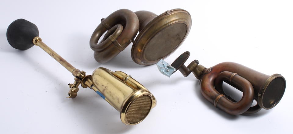 Three 'double twist' bulb horns, ((3)): Three 'double twist' bulb horns, comprising Desmo, Lucas No 38 (lacking bulb) and another un-named (lacking bulb). (3) Saleroom notices: Please note this lot is located in Las Vegas, Nevada, and in-ho