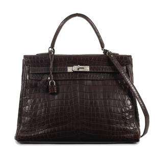 Hermès: a Matte Havane Niloticus Crocodile Retourne Kelly 35 2000 (includes padlock, keys, ...: Hermès: a Matte Havane Niloticus Crocodile Retourne Kelly 352000Toile lining and palladium hardwareCondition Grade C-35cm wide, 27cm high, 10cm handle drop, 40cm shoulder drop, includes padlock,