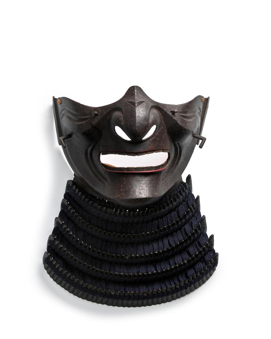 A RUSSET-IRON MENPŌ Edo period (1615-1868), 18th/19th century: A RUSSET-IRON MENPŌ Edo period (1615-1868), 18th/19th century Forged in two sections with a removable nose plate and deep wrinkles on the cheeks, bent anchoring posts below the cheek ridge, the l