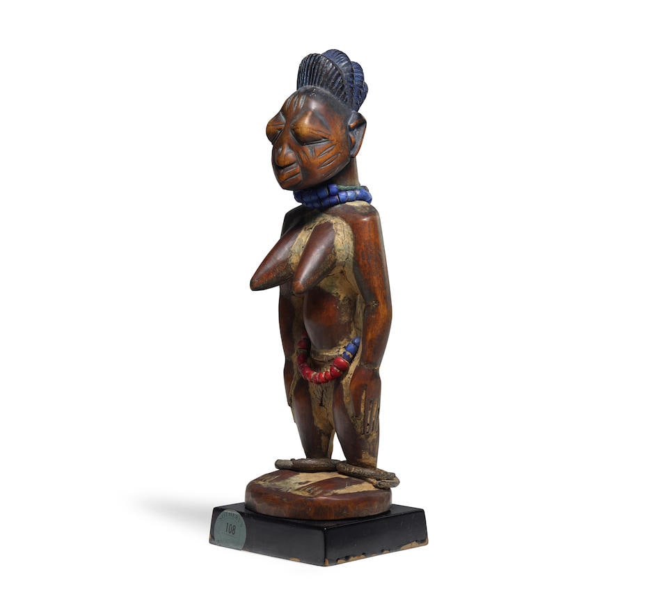Yoruba Female Twin Figure, Nigeria: Yoruba Female Twin Figure, Nigeria ibeji Wood, pigments, glass beads, metal, encrustations Height 10 3/4in (27.3cm) Provenance Sotheby's, New York, 6 May 1994, Lot 108 Stanley Lederman Collection, New