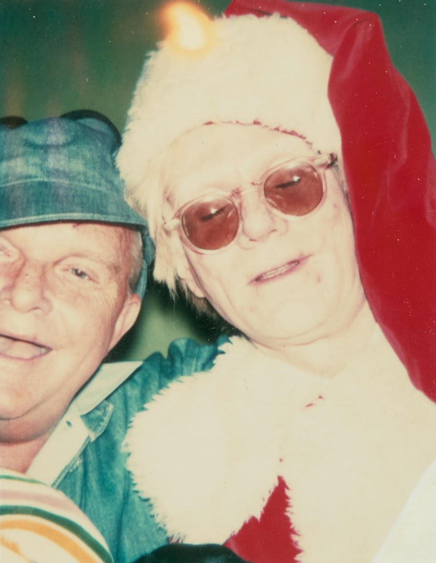 Brigid Berlin (1939-2020); Andy Warhol and Truman Capote Dressed for Christmas (vertical);: Brigid Berlin (1939-2020) Andy Warhol and Truman Capote Dressed for Christmas (vertical), 1978 Chromogenic print; framed, signed in ink on the reverse of the frame. 3 3/4 x 2 7/8 in. (9.5 x 7.3 cm.)