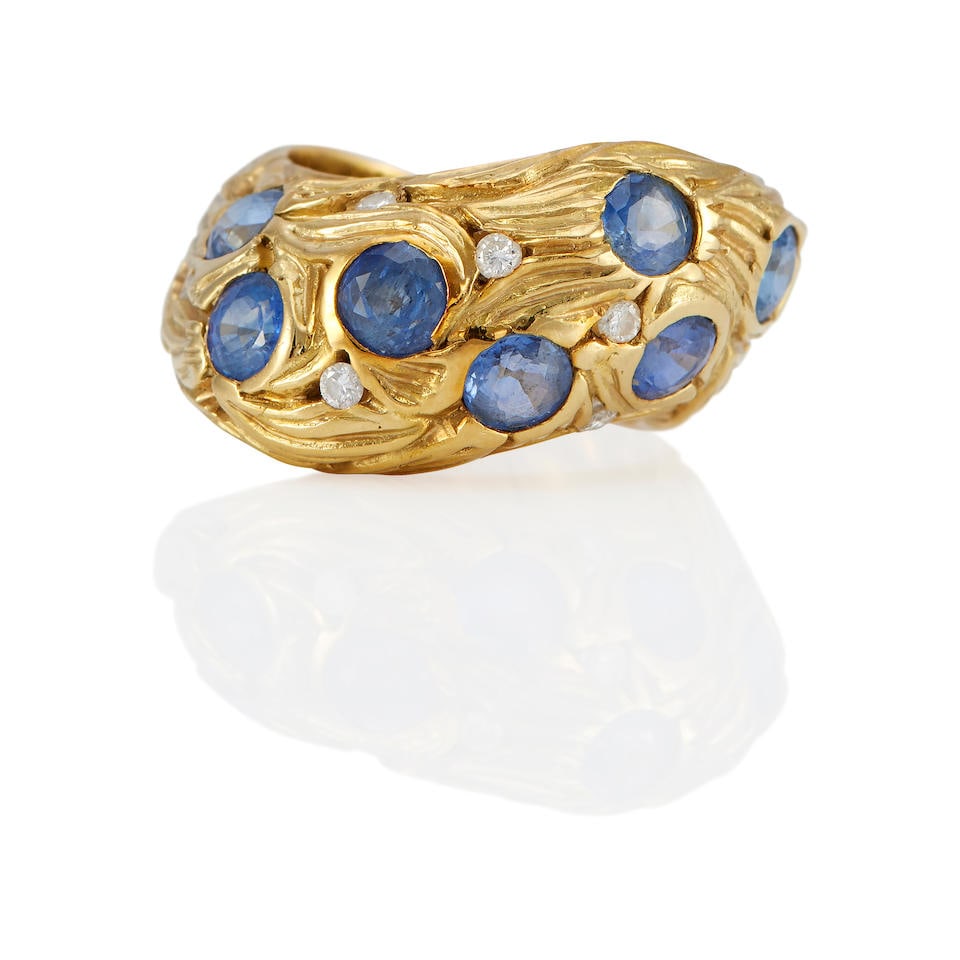 AN 18K GOLD, SAPPHIRE AND DIAMOND RING: AN 18K GOLD, SAPPHIRE AND DIAMOND RING • 18k yellow gold • 7 round sapphires • 6 round diamonds • Size 6 1/2 • Estimated gross weight: 10.9 grams Footnotes: OVERALL CONDI