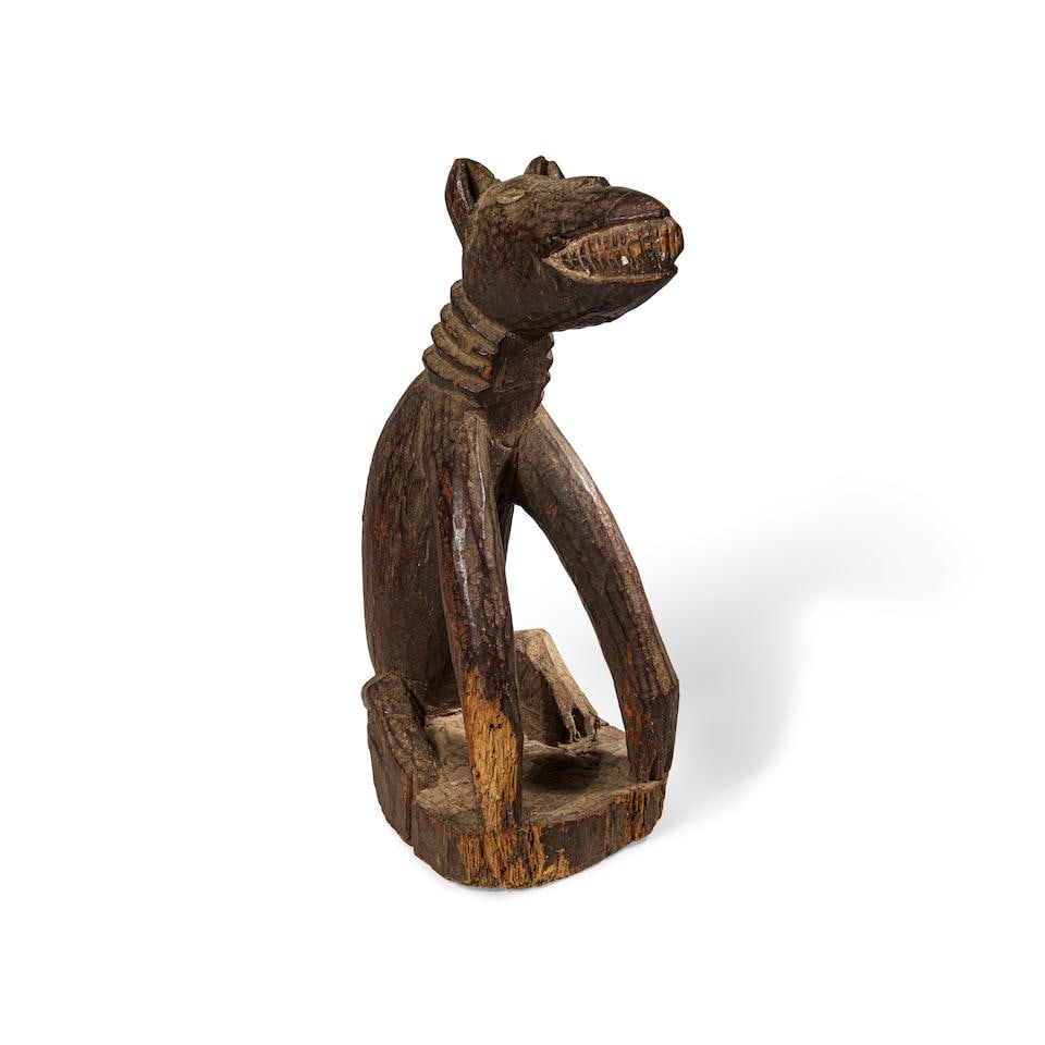 Kongo Seated Dog, Democratic Republic of the Congo: Kongo Seated Dog, Democratic Republic of the Congo Wood with dark brown patina Height 16 1/2in (42cm) Provenance Constance McCormick Fearing Collection, Santa Barbara, CA, acquired in the 1960s Thence
