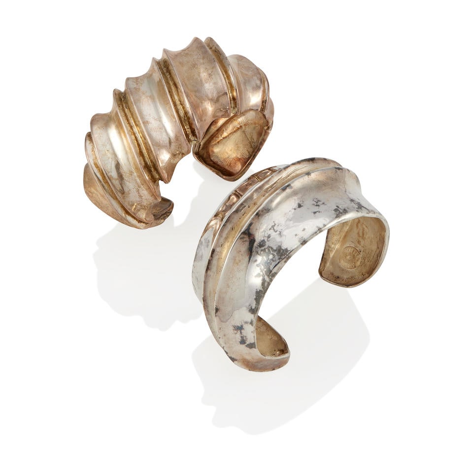 ROBERT LEE MORRIS: TWO SILVER CUFF BRACELETS: ROBERT LEE MORRIS: TWO SILVER CUFF BRACELETS • Silver • Each stamped Robert Lee Morris • Inner circumferences 5 1/2 in. with gap 7/8 in.; 5 3/4 in with gap 1 in. • Estimated gr