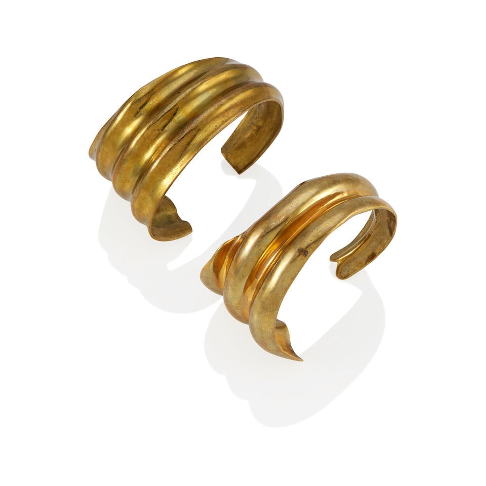 ROBERT LEE MORRIS: TWO BRASS STUDIO MODEL CUFF BRACELETS, 1981: ROBERT LEE MORRIS: TWO BRASS STUDIO MODEL CUFF BRACELETS, 1981 • Brass • Each inscribed Robert Lee Morris 1981 • Inner circumferences 5 3/8 and 5 3/4 in., gaps 1 in. • Estimate