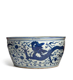 A MASSIVE MING BLUE AND WHITE DRAGON BASIN Jiajing six-character mark and of the period: A MASSIVE MING BLUE AND WHITE DRAGON BASIN Jiajing six-character mark and of the period The circular basin with sharply rising sides and painted in rich dark cobalt blue with two lithe five-clawed hor