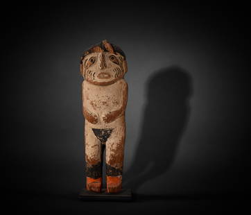 A Hopi katsina doll: A Hopi katsina dollDepicting Heheya-aumutaqa katsina or Heheya's Uncle, depicted with arms bent at the elbows, wearing a pack with painted raincloud on the back, zigzag motifs on the face. height 8