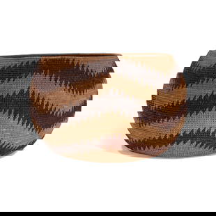 A Paiute or Miwok basket: A Paiute or Miwok basket Designed with three serrated zigzag bands encircling the body, the base worked with a stepped wheel device, with a repaired rim split. height 6 1/4in, diameter 10in Footnotes: