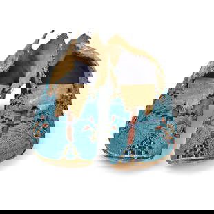 A pair of Tsitsistas/Suhtai (Cheyenne) or Inunaina (Arapaho) beaded moccasins: A pair of Tsitsistas/Suhtai (Cheyenne) or Inunaina (Arapaho) beaded moccasins Likely of buffalo hide construction, worked with stepped chevrons, stacked diamonds, and additional geometric elements acr