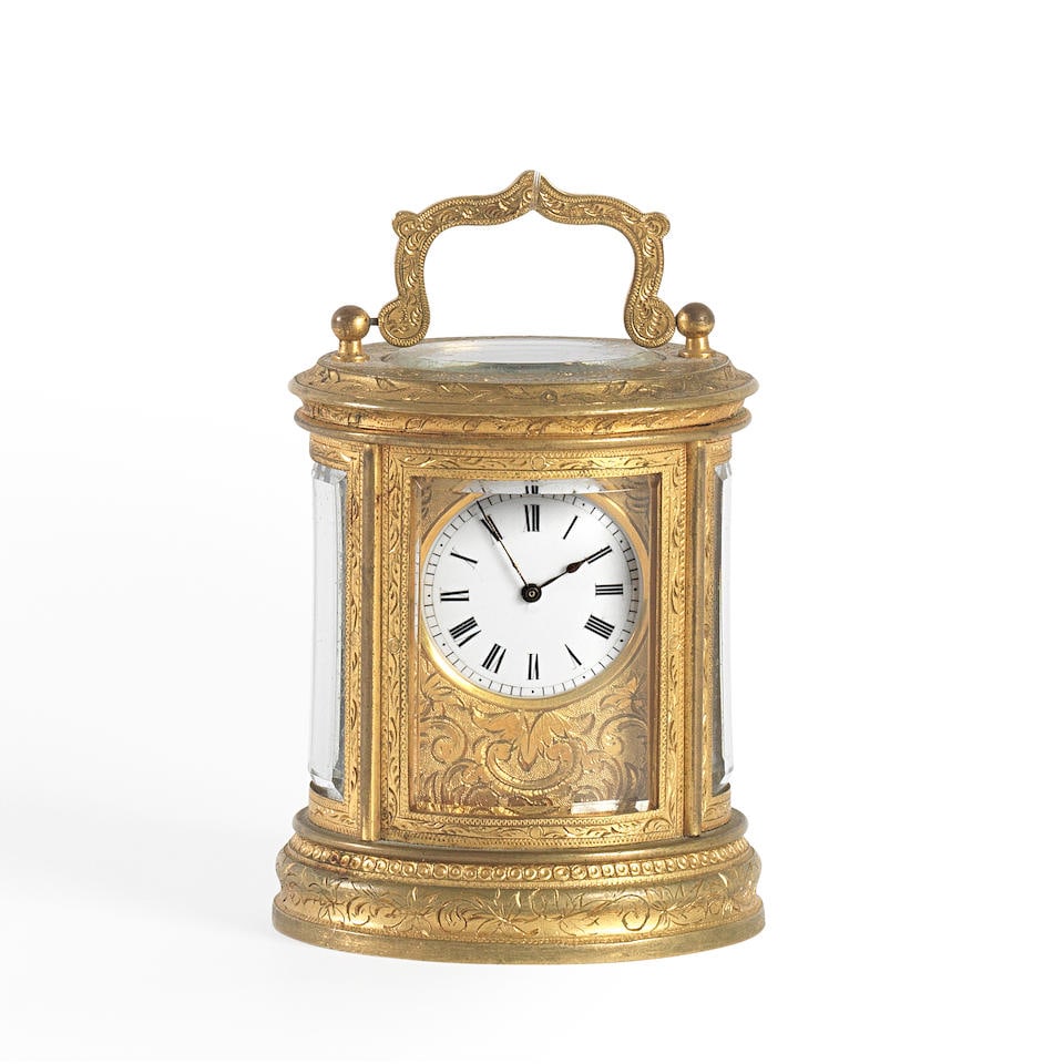 Drocourt. A small oval gilt brass carriage timepiece Circa 1900 (1 of 2)