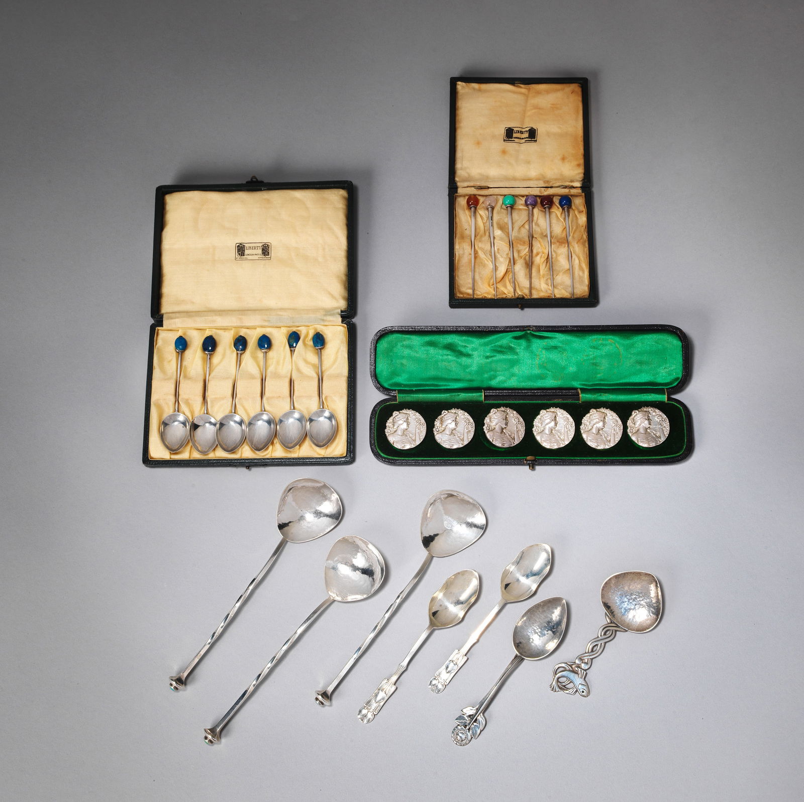A.E. JONES Three spoons, dated 1907: A.E. JONESThree spoons, dated 1907Silver, with shaped bowls and twisted stems, the terminals set with turquoise matrix cabochons, stamped 'A.E. Jones, Birmingham 1907; together with a set of six Liber