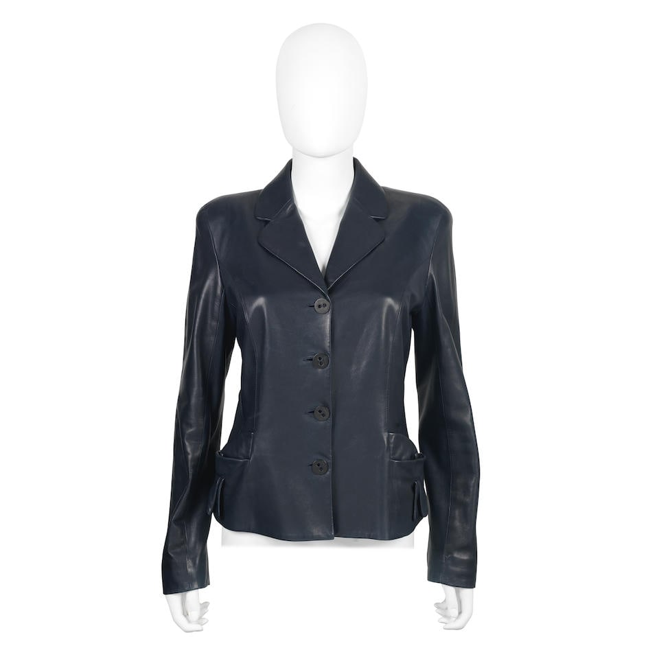 John Galliano for Christian Dior: a Navy Lambskin Jacket 2003: John Galliano for Christian Dior: a Navy Lambskin Jacket 2003 Smooth blue leather with tie detail to pocket and button fastening Condition Grade B Labelled size 42 Lot to be sold without reserve. For