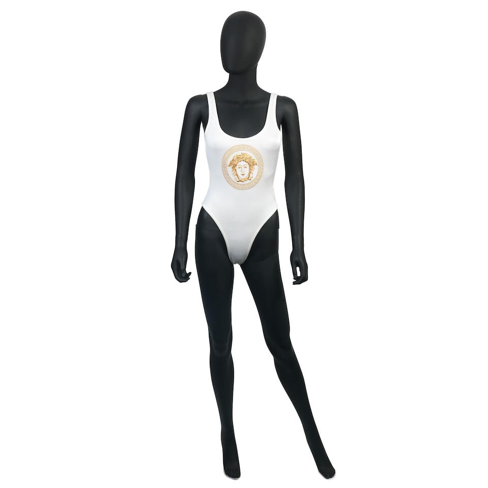 Versace Mare: a White and Gold Medusa Swimsuit 1990s: Versace Mare: a White and Gold Medusa Swimsuit 1990s White waffle fabric with embroidered gold Medusa head design, high-cut and low back Condition Grade A- Labelled size IT 42 For further information