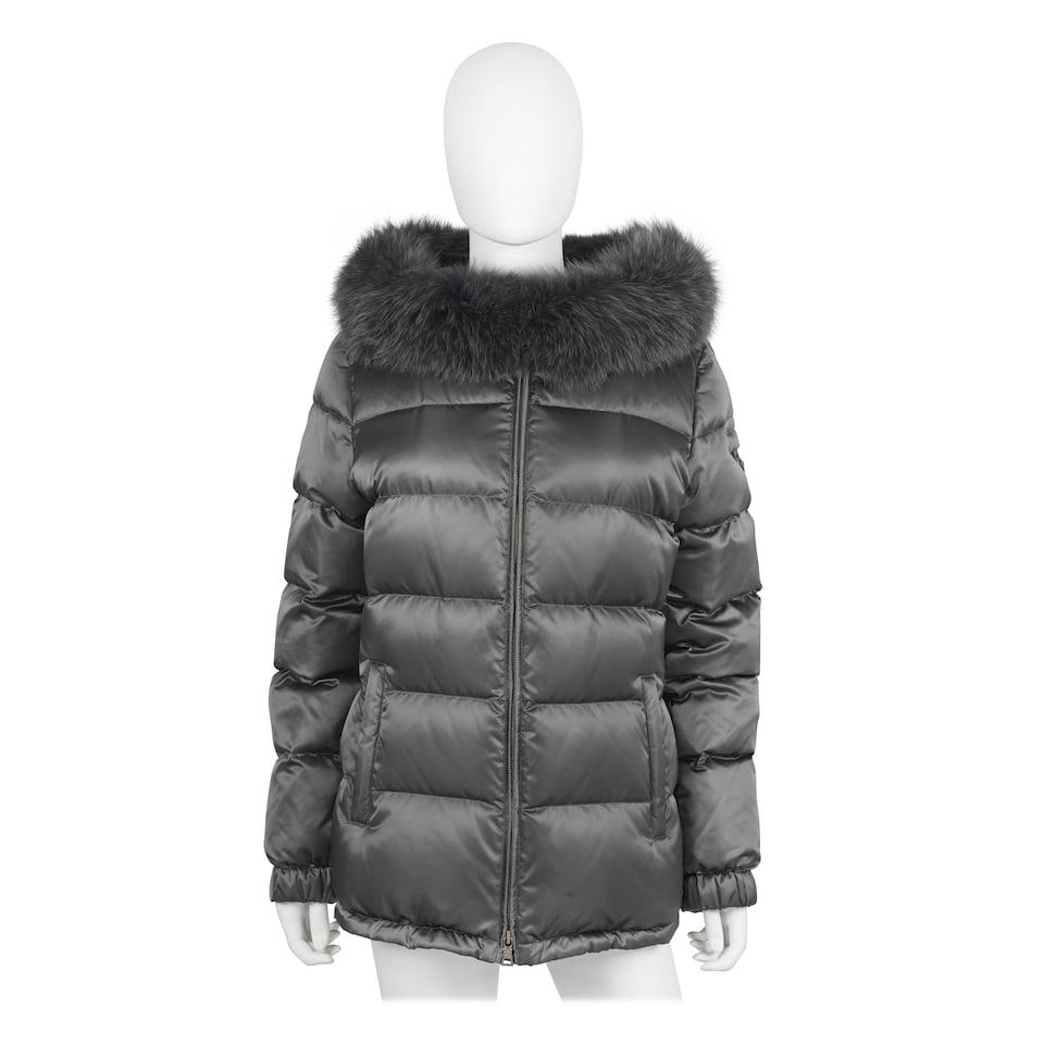 Prada: a Dark Grey Down Puffer Jacket: Prada: a Dark Grey Down Puffer Jacket Down jacket with blue dyed fox fur trimmed hood Condition Grade A Size 46 For further information on this lot please visit Bonhams.com For further information abo