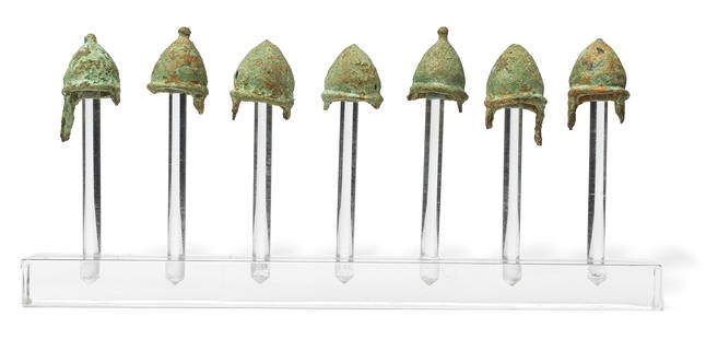 A group of seven Greek bronze miniature votive pilos helmets 7: A group of seven Greek bronze miniature votive pilos helmets Magna Graecia, circa 4th-3rd Century B.C. 2.8cm high max. (7) Footnotes: Provenance: Kuizenga collection, the Netherlands, acquired in Dor