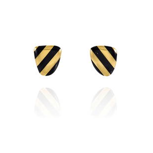 ANGELA CUMMINGS FOR TIFFANY & CO.: A PAIR OF 18K GOLD AND ONYX 'STRIPED SHIELD' EARCLIPS: ANGELA CUMMINGS FOR TIFFANY & CO.: A PAIR OF 18K GOLD AND ONYX 'STRIPED SHIELD' EARCLIPS Each of shield-shape with stripes of onyx inlay; signed Tiffany & Co. with maker's mark; length 1 in.