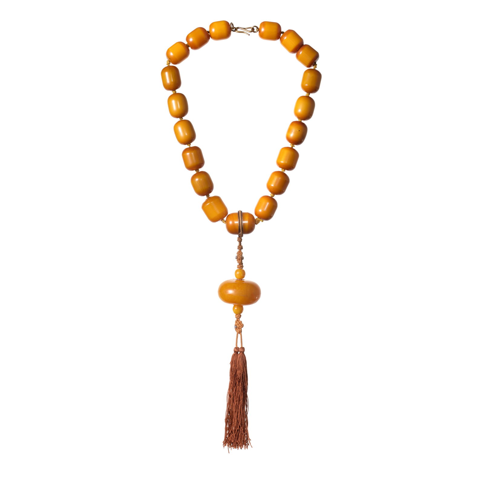 GRIMA: DIAMOND-SET AMBER BEAD NECKLACE: GRIMA: DIAMOND-SET AMBER BEAD NECKLACE Of Eastern inspiration, the row of graduated oblong beads issuing an oblate bead, via a brown silk cord with tassel terminal and Chinese knot motif, signed Grima