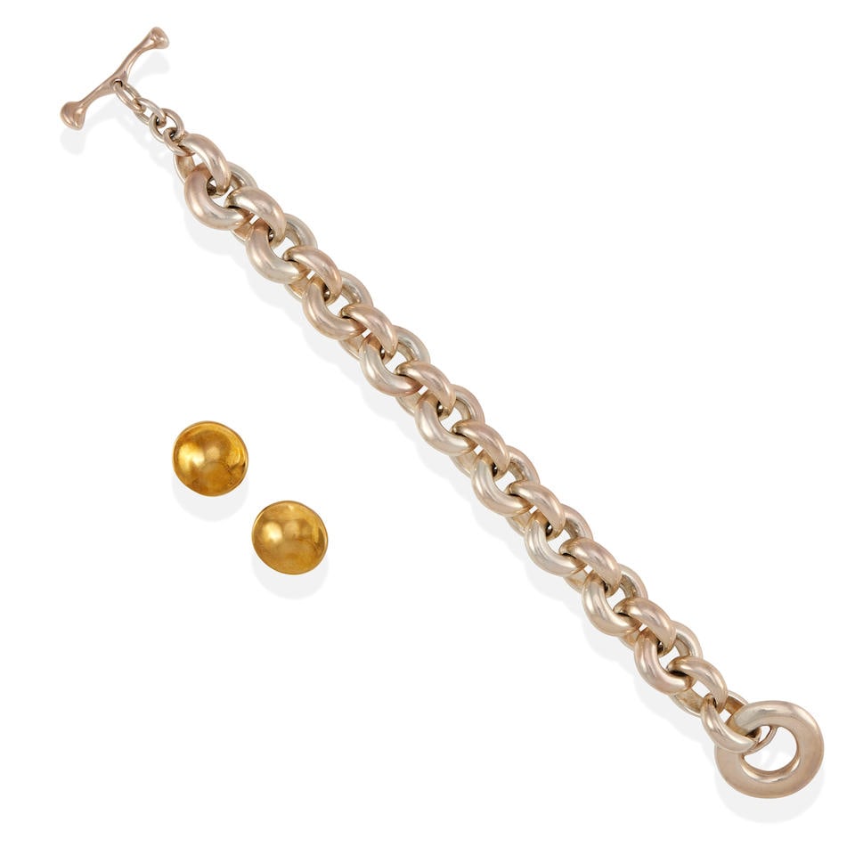 A PAIR OF 18K GOLD EARRINGS AND A SILVER BRACELET: A PAIR OF 18K GOLD EARRINGS AND A SILVER BRACELET • 18k yellow gold and silver • Bracelet attributed to Robert Lee Morris with partial maker's mark • Earrings measure 3/4 in., bracel