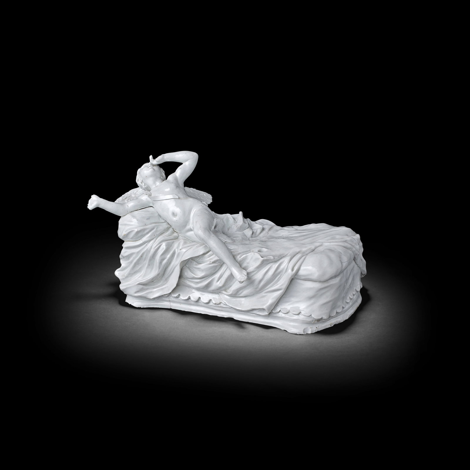 A Doccia group of Cupid and Psyche, circa 1750: A Doccia group of Cupid and Psyche, circa 1750After the model by Giovanni Battista Foggini, the reclining Cupid stretching out his right arm, his leg just stretching over the edge of the bed, leaning