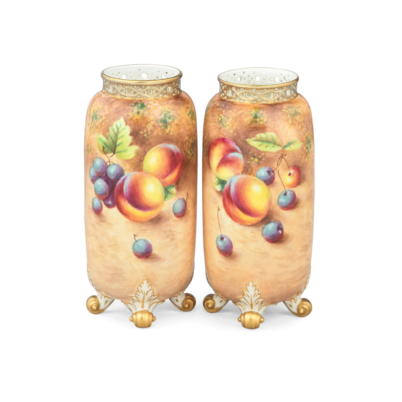 A pair of Royal Worcester 'Painted Fruit' vases by William Roberts, circa 1960: A pair of Royal Worcester 'Painted Fruit' vases by William Roberts, circa 1960Of cylindrical form with pierced gallery rims and four scroll feet picked out in gold, painted all around with fruit inclu