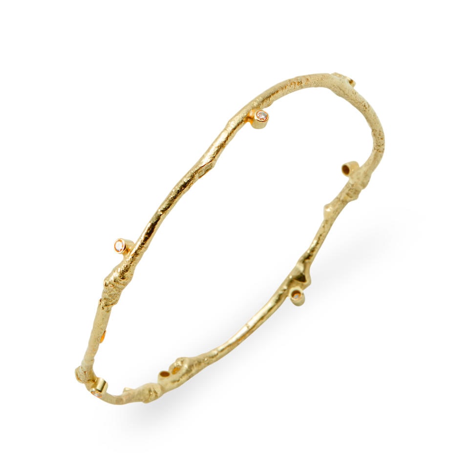 SAM SHAW: AN 18K GOLD AND DIAMOND BANGLE BRACELET: SAM SHAW: AN 18K GOLD AND DIAMOND BANGLE BRACELET Designed as twigs set with full-cut diamonds, weight 8.5 dwt, signed Shaw, interior circumference 7 1/4 in. For further information on this lot plea