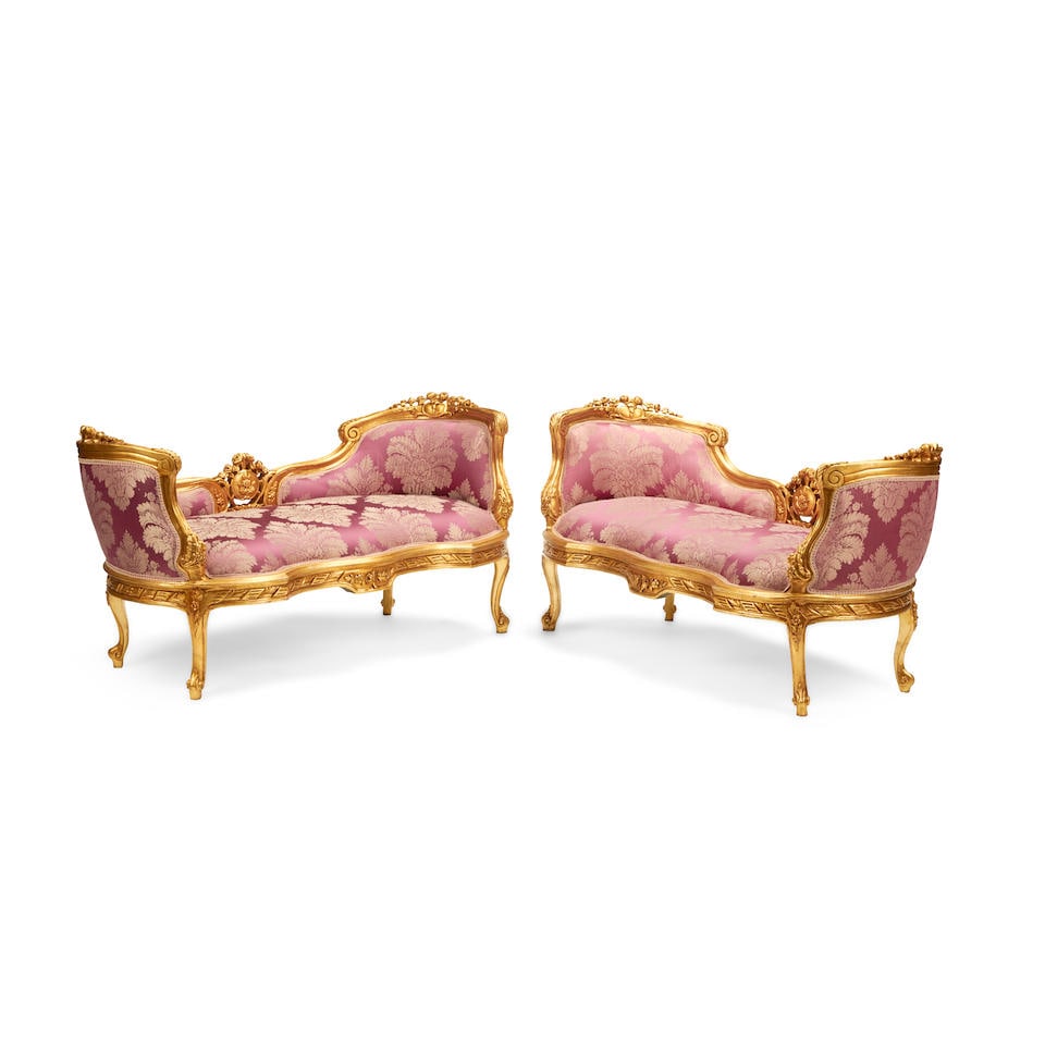 A PAIR OF LOUIS XV STYLE GILTWOOD SETTEES: A PAIR OF LOUIS XV STYLE GILTWOOD SETTEES height 29in (74cm); width 58in (148cm); depth 28in (71cm) This lot is subject to the following lot symbols: W W If the lot is not picked up immediately follow
