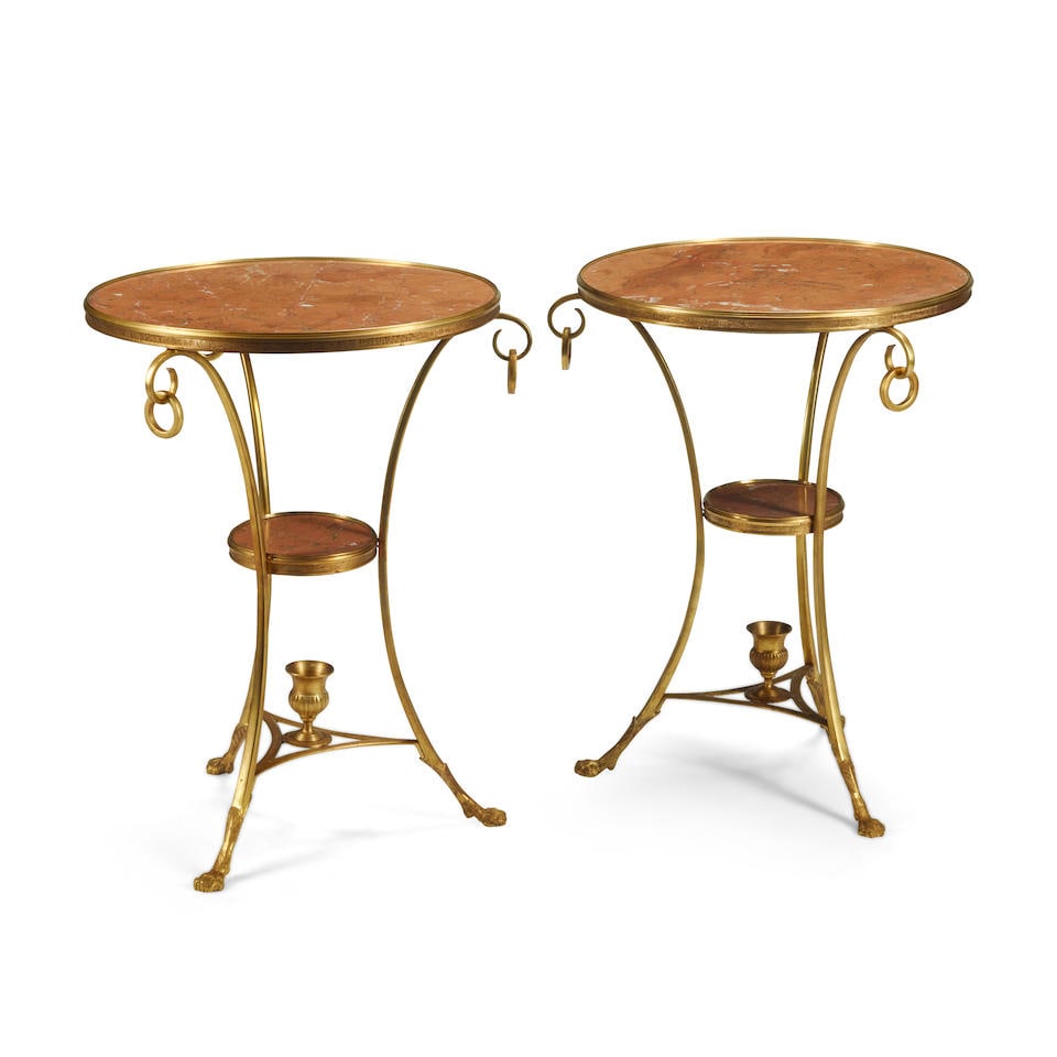 A PAIR OF NEOCLASSICAL STYLE MARBLE AND GILT BRONZE GUERIDONS: A PAIR OF NEOCLASSICAL STYLE MARBLE AND GILT BRONZE GUERIDONS height 27 1/2in (70cm); diameter 22in (56cm) For further information on this lot please visit Bonhams.com For further information about th