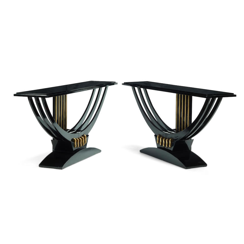 A PAIR OF ART DECO STYLE BLACK LACQUERED CONSOLE TABLES: A PAIR OF ART DECO STYLE BLACK LACQUERED CONSOLE TABLES height 34 1/2in (87cm); width 71in (181cm); depth 15 3/4in (40cm) This lot is subject to the following lot symbols: W W If the lot is not picked
