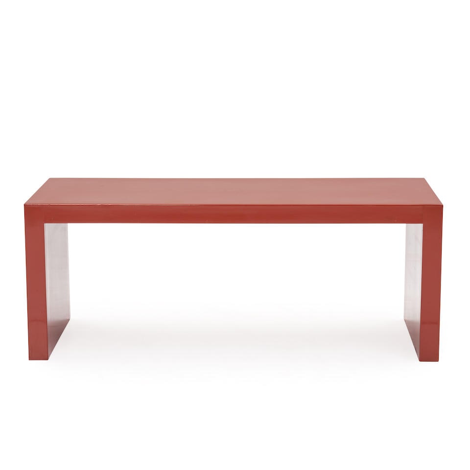 A SCARLET LACQUER COFFEE TABLE,: A SCARLET LACQUER COFFEE TABLE, 1960s, rectangular top raised on conforming end supports, ht. 17 33/4, wd. 46 3/4, dp. 19 3/4 in. Footnotes: Provenance: Sibyl Colefax & John Fowler, London. For furth