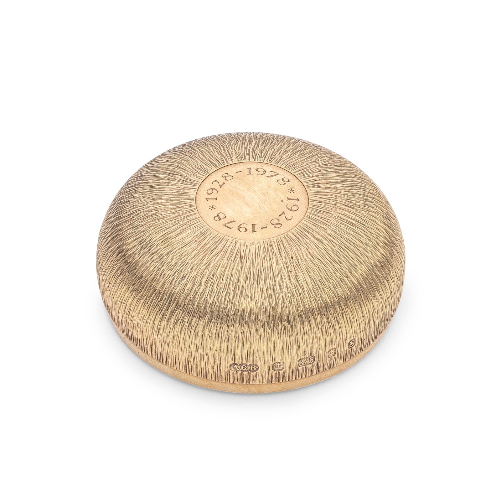 GERALD BENNEY: a 9 carat gold paper weight London 1978: GERALD BENNEY: a 9 carat gold paper weight London 1978 Domed with bark-effect textured sides, the top with a polished circular reserve with engraved dates '1928 - 1978', loaded base, diameter at base