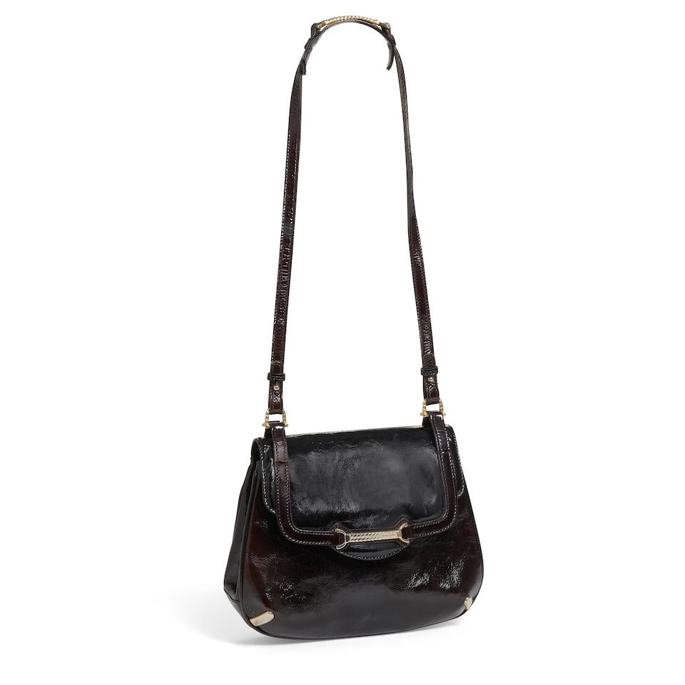 GUCCI: PATENT HORSEBIT BAG 1955: GUCCI: PATENT HORSEBIT BAG 1955 • Black Patent Leather Exterior • Patina Gold Tone Braided Equestrian Hardware • Button Snap Flap Closure • Leather Lined Interior with Zip and