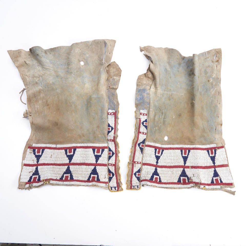 A pair of Tsis tsis'tas (Cheyenne) beaded hide leggings lg. 17, wd. 11 1/2 in. (1 of 2)