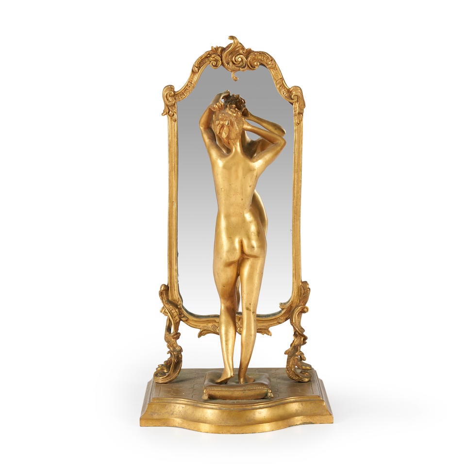 Emile Pinedo (French, 1840-1916) Gilt Bronze Model of a Nude with Mirror,: Emile Pinedo (French, 1840-1916) Gilt Bronze Model of a Nude with Mirror, the figure standing by a cheval mirror, standing on an etched tile floor, inscribed signature, ht. 13 in. For further informat