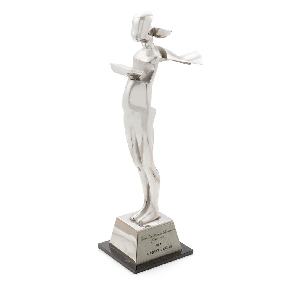 AN ANNIE FLANDERS 1984 CFDA AWARD STATUETTE. TROVA, ERNEST, after. Stainless steel statuette on ... (1 of 1)