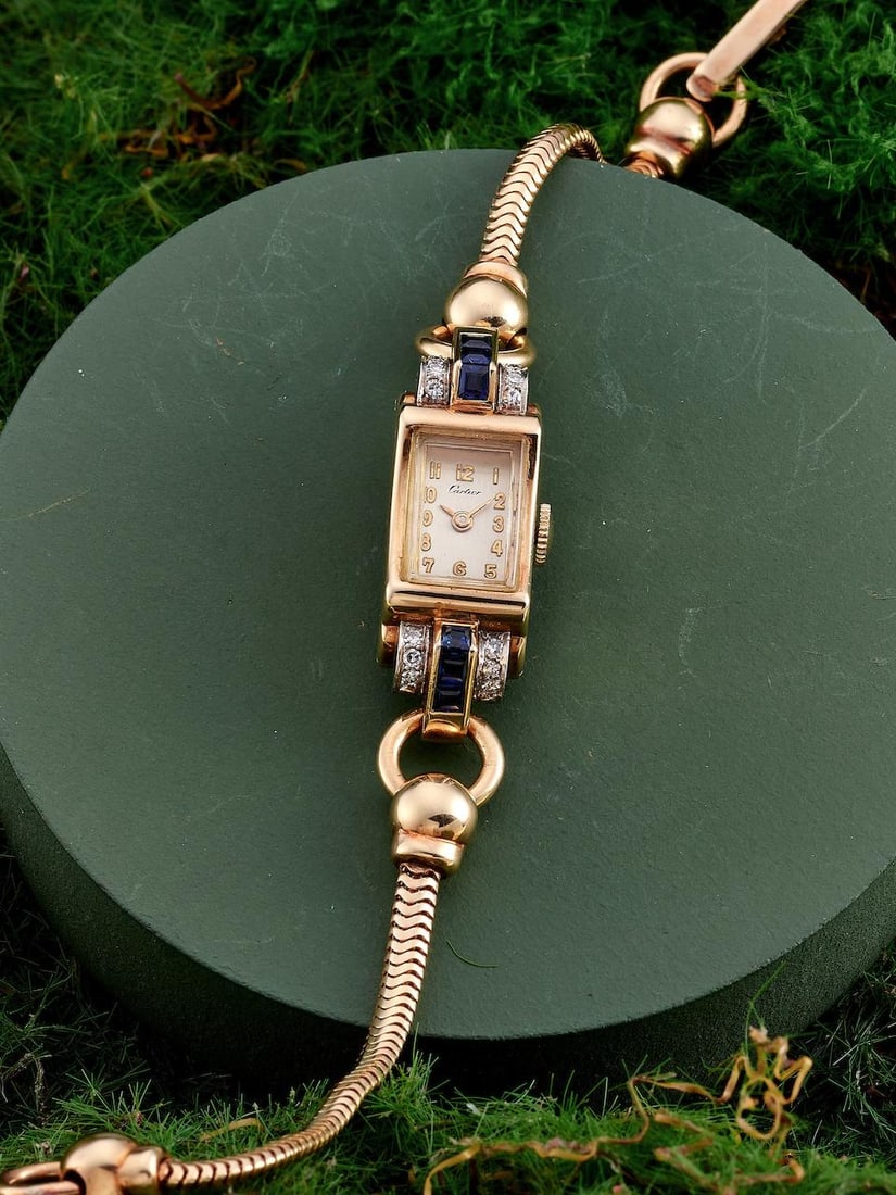 CARTIER | A RARE AND ELEGANT 14K YELLOW GOLD, BLUE SAPPHIRE AND DIAMOND-SET BRACELET WATCH WITH ...: CARTIER | A RARE AND ELEGANT 14K YELLOW GOLD, BLUE SAPPHIRE AND DIAMOND-SET BRACELET WATCH WITH SERVICE RECEIPT, CIRCA 1948 Case No: 022294 Calibre: Manual winding, signed by Cresarrow Watch Co. Dial: