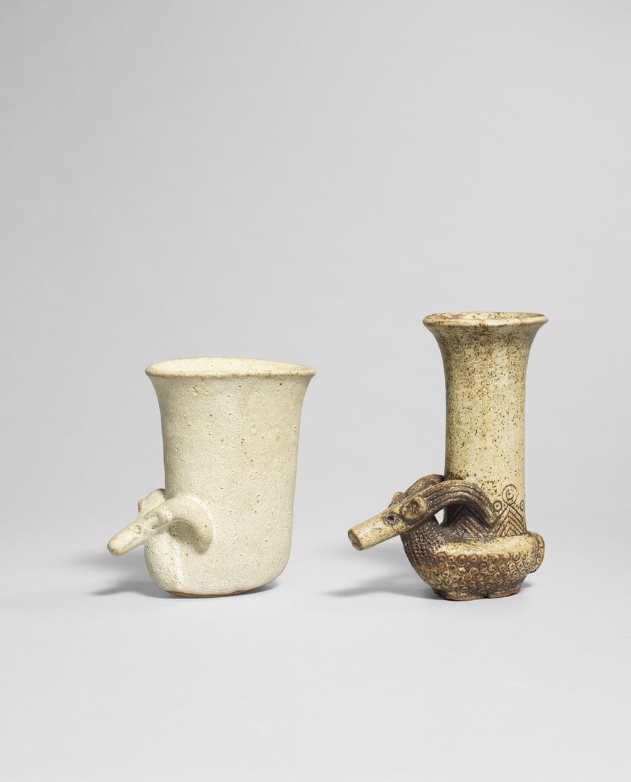 Ian Godfrey Two 'Antelope' cups, circa 1975: Ian Godfrey Two 'Antelope' cups, circa 1975 Stoneware, matt cream glaze with finely pitted surface, pale brown and manganese glaze. 11.5 x 6.5 x 9.5 cm and 14 x 6 x 10.5 cm, respectively Footnotes: Pr