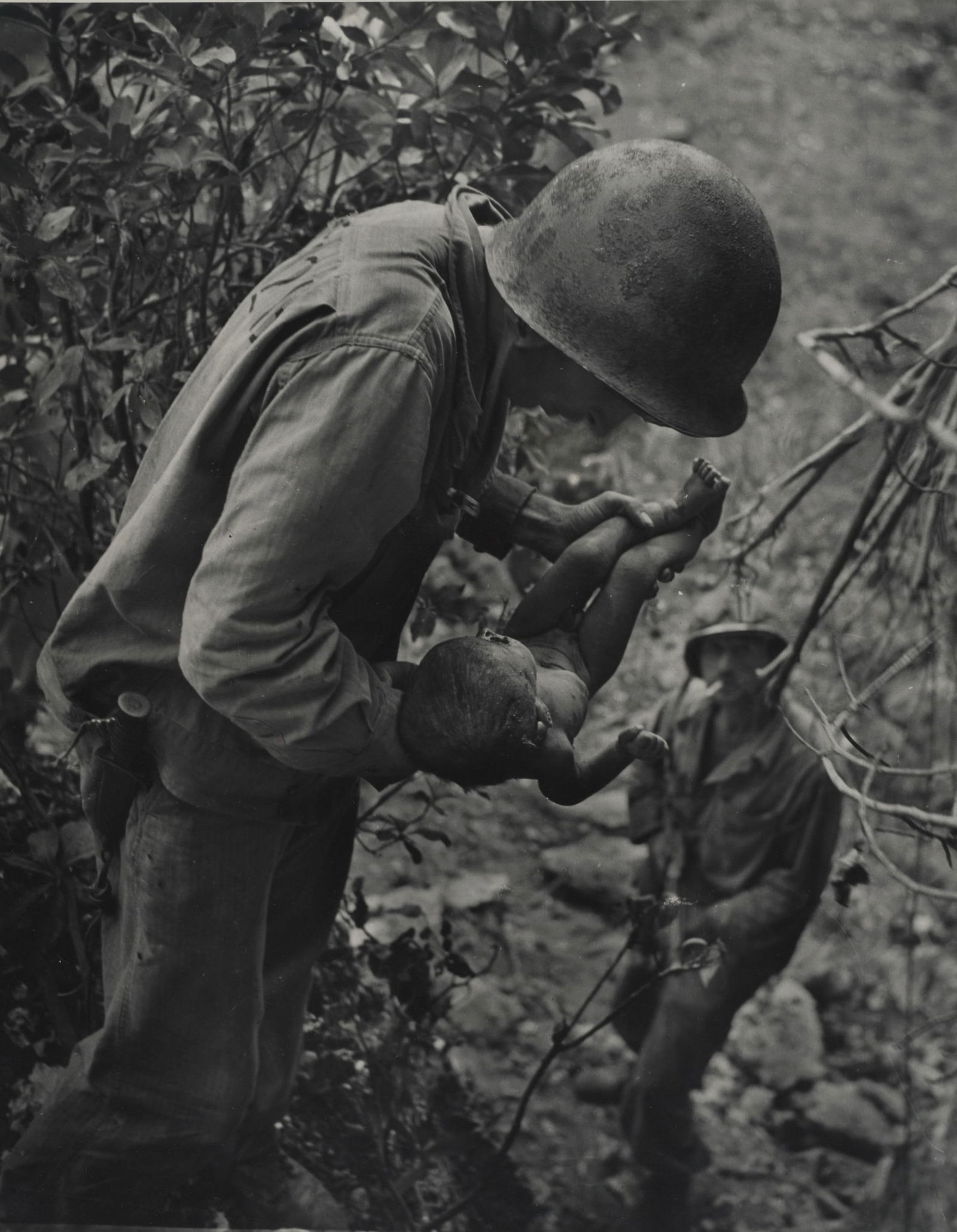 W. Eugene Smith (1918-1978); Saipan (Soldier Holding Baby);: W. Eugene Smith (1918-1978) Saipan (Soldier Holding Baby), 1944 Gelatin silver exhibition print, printed later; mounted to thick board, the photographer's estate stamp on the reverse. 18 1/4 x 14 1/4