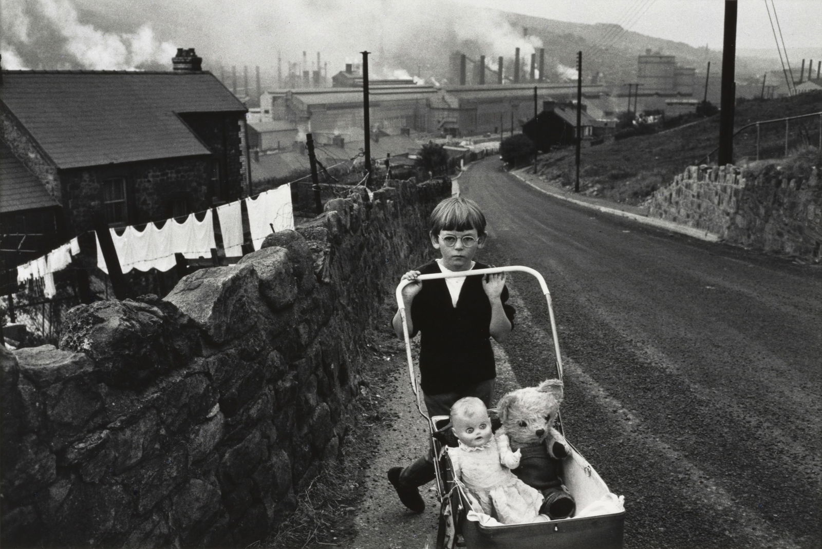 Bruce Davidson (born 1933); 'Wales' (Boy Pushing Carriage);: Bruce Davidson (born 1933) 'Wales' (Boy Pushing Carriage), 1965 Gelatin silver print, printed c. 1975; signed, titled, and dated in pencil on the reverse. 8 x 12 in. (20.3 x 30.4 cm.) sheet 11 x 13 3/