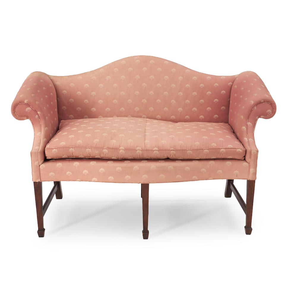 JEFFREY GREENE CHIPPENDALE-STYLE MAHOGANY AND UPHOLSTERED CAMELBACK SETTEE: JEFFREY GREENE CHIPPENDALE-STYLE MAHOGANY AND UPHOLSTERED CAMELBACK SETTEE • New England • 20th century • With scrolled arms • Cotton mauve upholstery • 37' height •