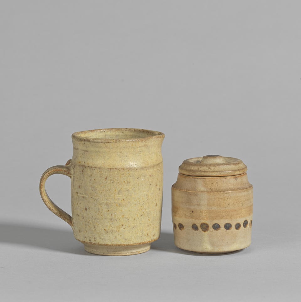Ian Godfrey Jug: Ian Godfrey Jug Stoneware, matt cream glaze with finely pitted surface; together with a Lidded jar, stoneware with light brown and cream glazes, and brushed decoration to body, lid, and interior. Jug: