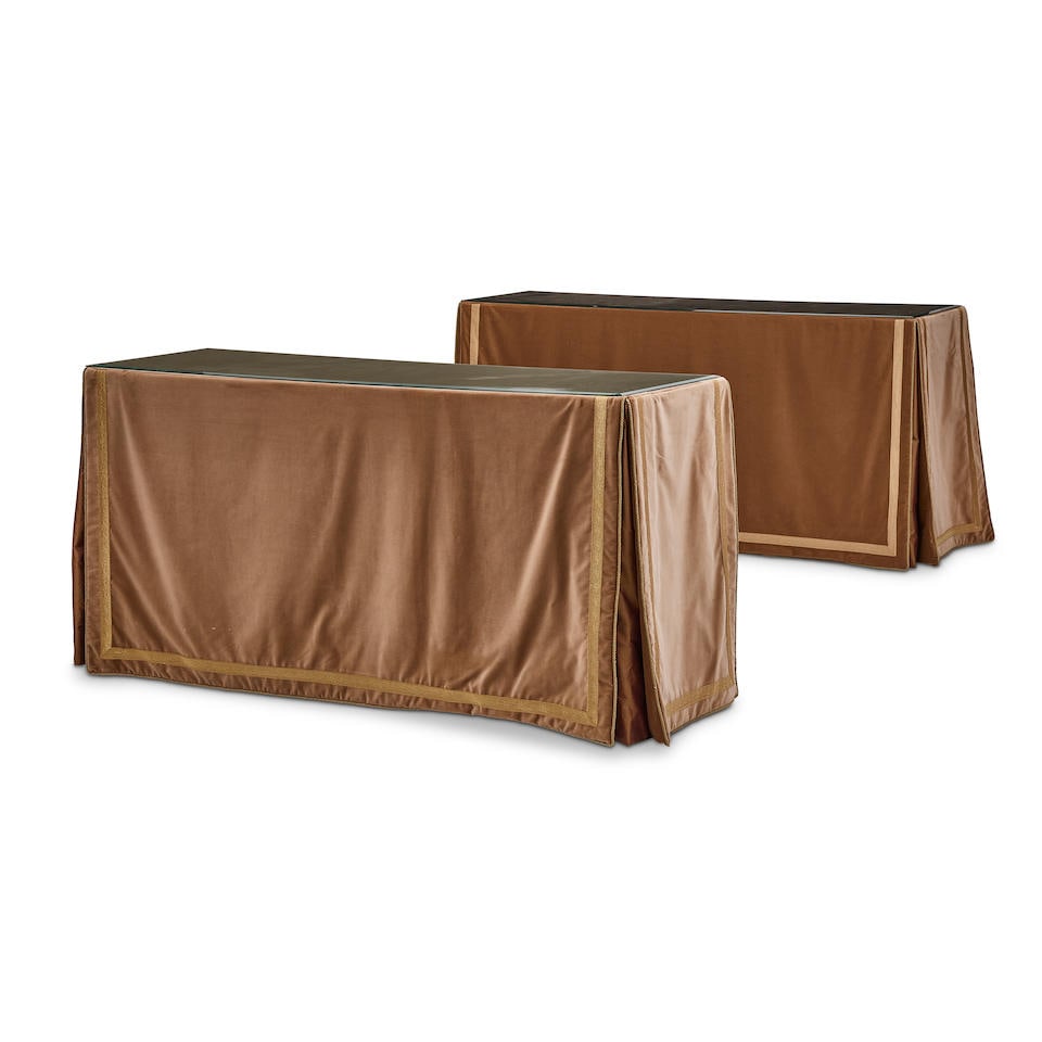 A PAIR OF VELVET DRAPPED CONSOLE TABLES: A PAIR OF VELVET DRAPPED CONSOLE TABLES With glass tops. height 33 1/4in (84cm); width 64 1/2in (164cm); depth 21 3/4in (55cm) For further information on this lot please visit Bonhams.com For further