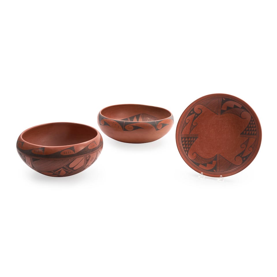 Three Hopi redware bowls ht. 4 1/2, wd. 12, ht. 5, wd. 9 1/2, and ht. 1 1/2, wd. 9 3/4 in.: Three Hopi redware bowls The largest decorated with abstract avian devices on the interior and around the rim on the exterior, signed indistinctly, a second bowl signed, 'R Huma Tewa Village,' and a p