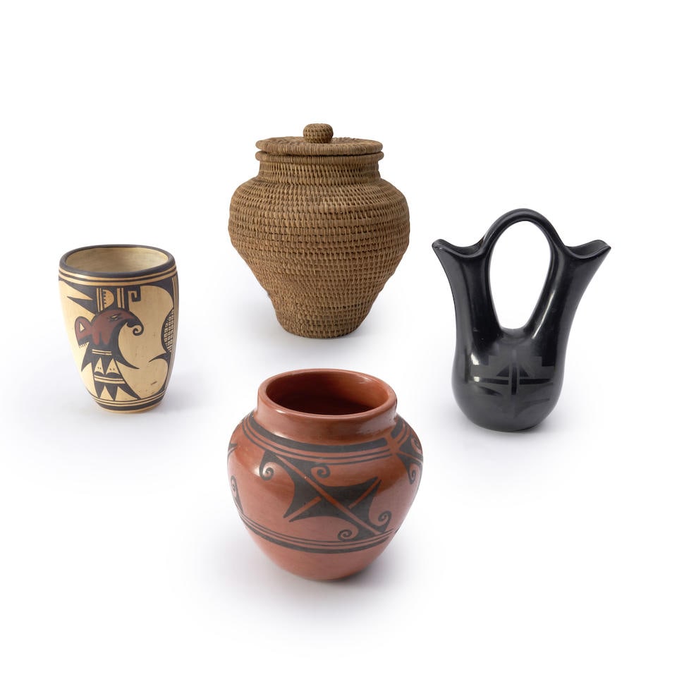 Four Southwest pottery vessels ht. 5 3/4, 5, 8, 6 and 9 1/4 in.: Four Southwest pottery vessels Including a Hopi vase, signed, 'S. Carl,' a redware pottery jar, a small blackware wedding vase, and a Hopi vase, signed, 'Navaquavi,' (with repairs to cracks below the