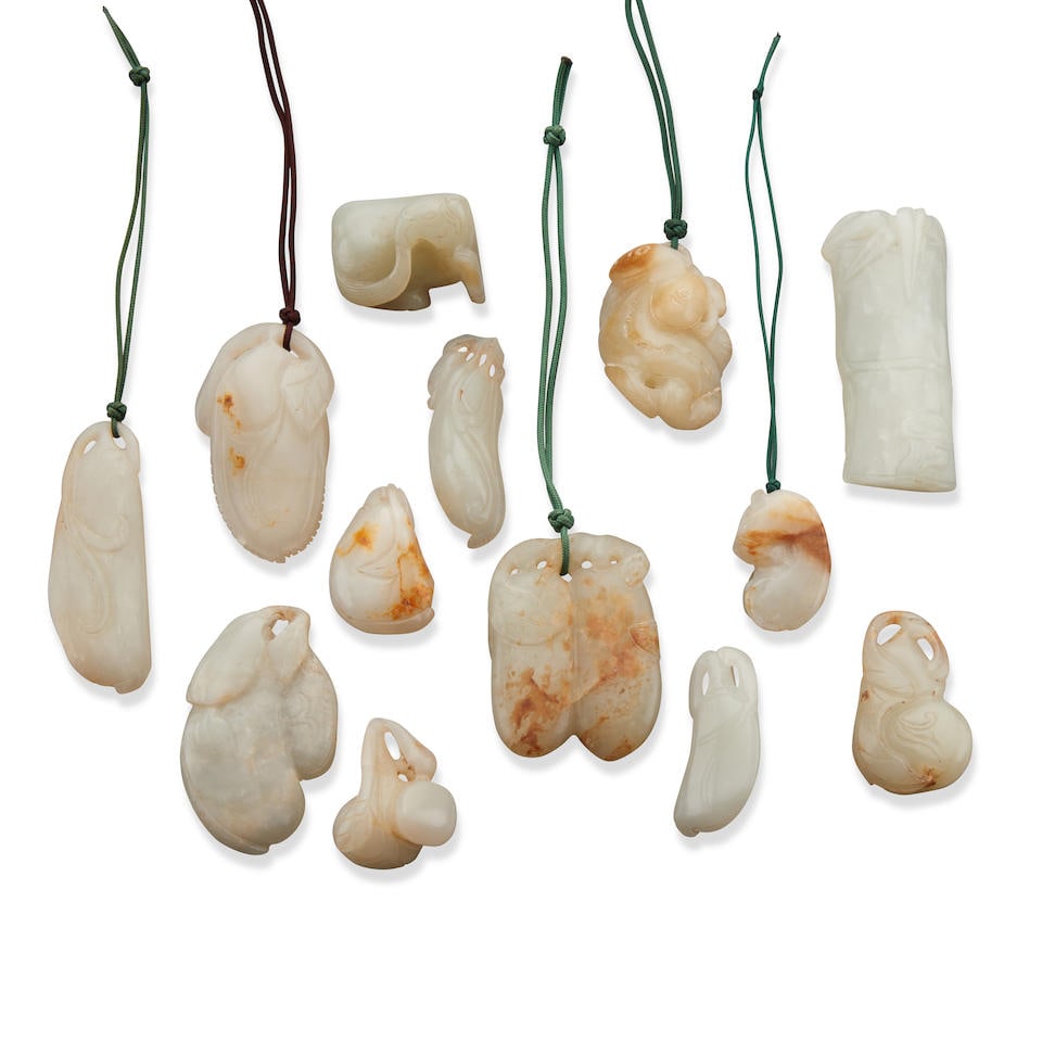 A GROUP OF THIRTEEN SMALL WHITE AND RUSSET JADE TOGGLES AND PENDANTS Late Qing dynasty - 20th ce... (1 of 1)