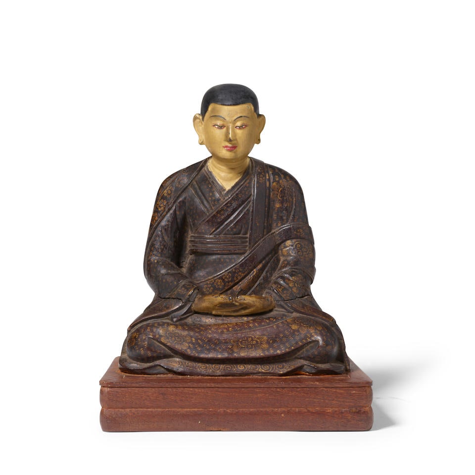 A GILT AND POLYCHROME WOOD FIGURE OF AN ARHAT Tibet, 17th/18th century (wood stand) (1 of 1)