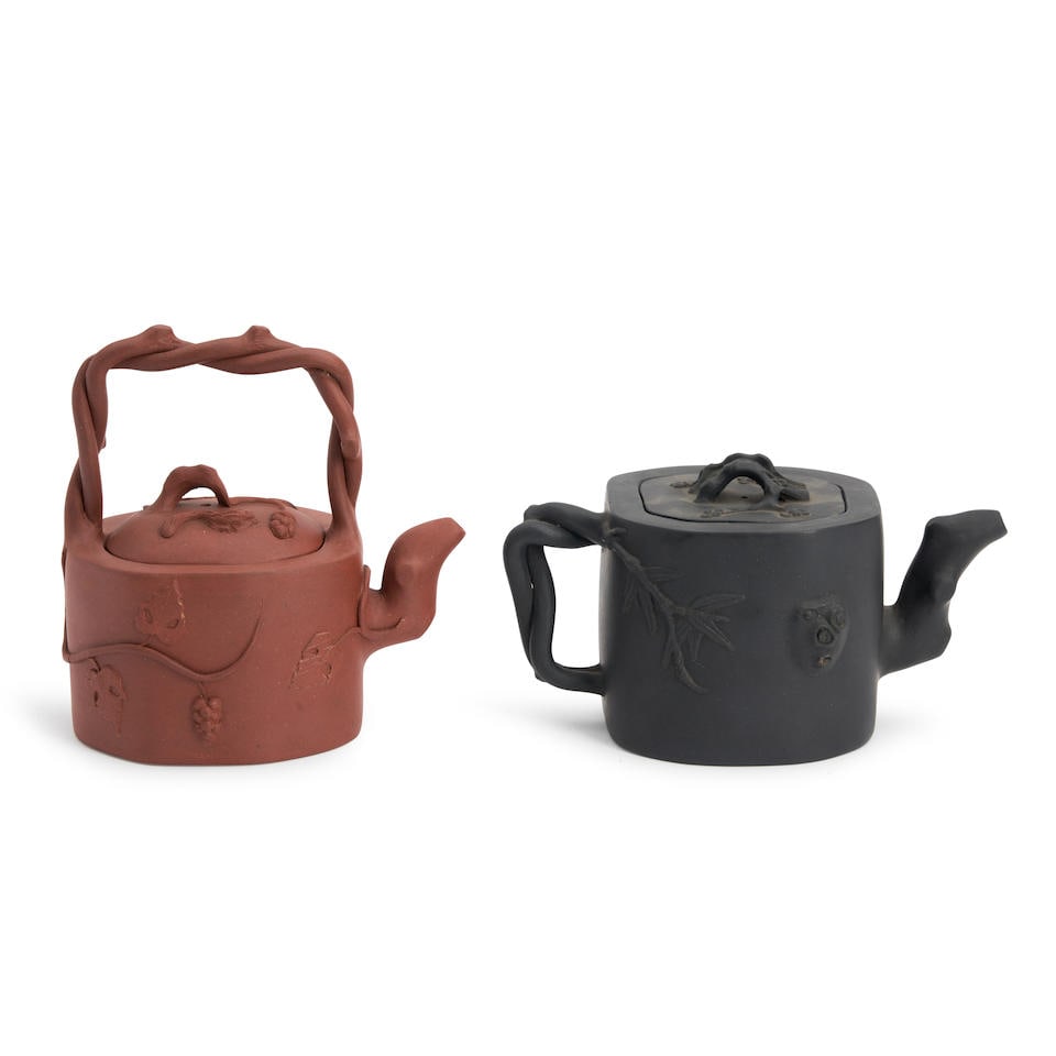 Two Yixing Tea Pots, China, 19th/20th century,: Two Yixing Tea Pots, China, 19th/20th century, each decorated with vines and leaves, a redware with overhead double entwined twig bale handle, ht. 6; and a black bodied with double entwined handle, ht