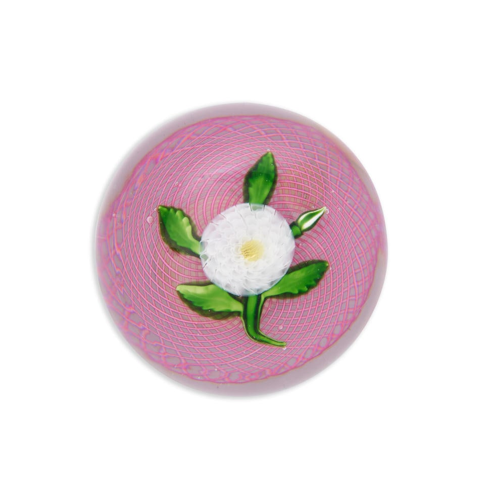 ANTIQUE ST. LOUIS WHITE CHAMOMILE PAPERWEIGHT, France, c. 1850, the flower on a pink filigree cu...: ANTIQUE ST. LOUIS WHITE CHAMOMILE PAPERWEIGHT, France, c. 1850, the flower on a pink filigree cushion, unsigned, Christie's sticker, ht. 2 1/8, dia. 3 1/8 in. Footnotes: Provenance The Joan and Rif Fr