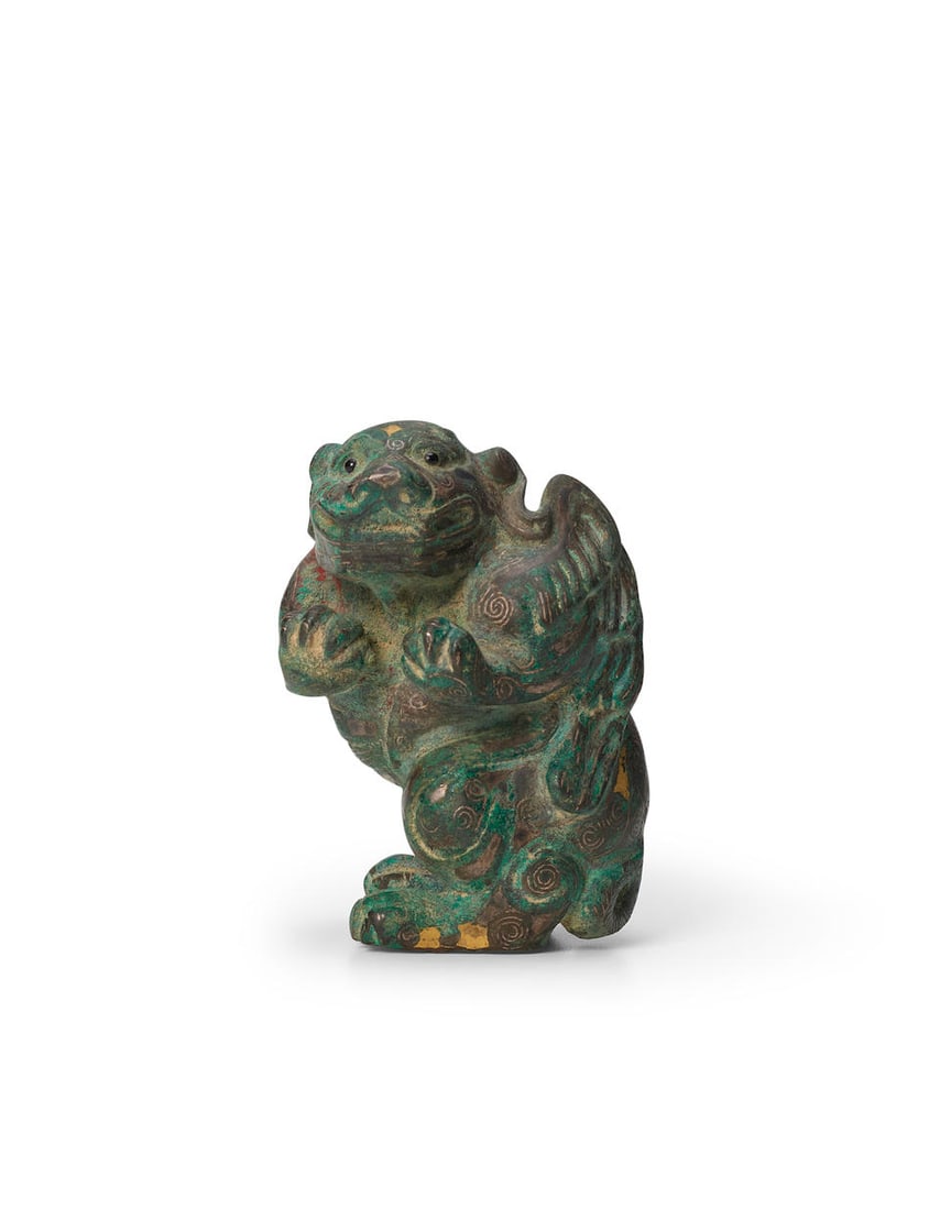 A GOLD- AND SILVER-INLAID BRONZE MODEL OF A WINGED MYTHICAL BEAR Warring States/Han style (1 of 4)