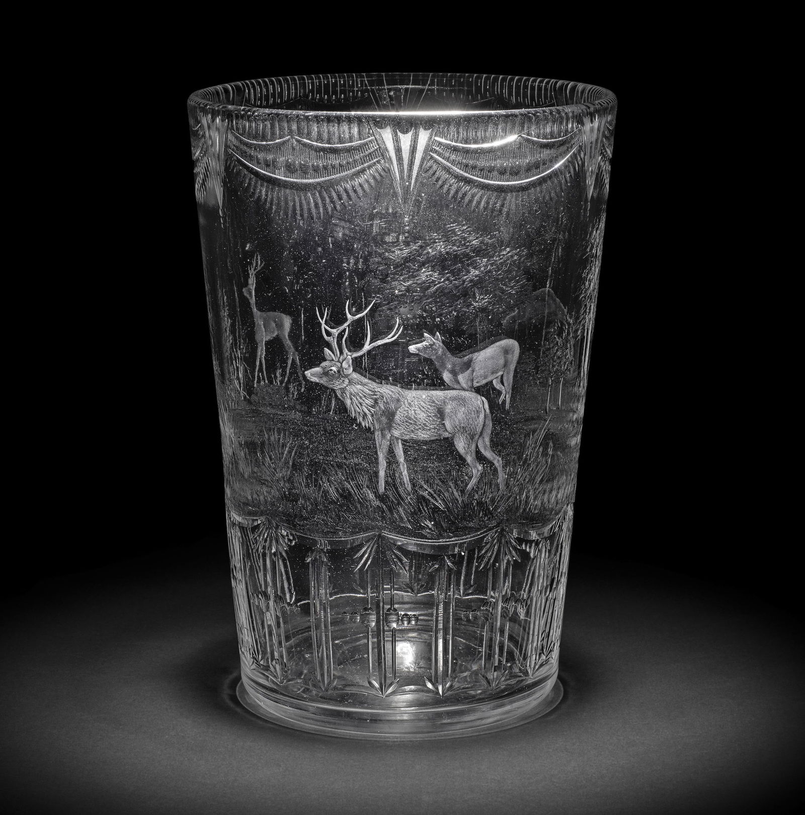 A Thomas Webb and Sons engraved 'rock crystal' style vase by George Pope, circa 1950: A Thomas Webb and Sons engraved 'rock crystal' style vase by George Pope, circa 1950 Of generous tapering bucket shape, finely decorated with a deer in a continuous hilly landscape, a stag and doe loo